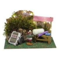 Puesto de telas con luz y vendedora de durexina